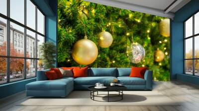 Golden and silver ball hanging on a Christmas tree. Wall mural