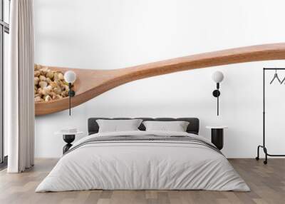 Buckwheat in wood spoon on the white background Wall mural