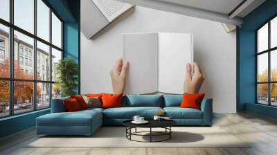 female hands holding an open magazine mockup l Wall mural