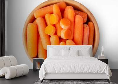 Top view of a group of organic small baby carrots in wood bowl isolated on a white background Wall mural