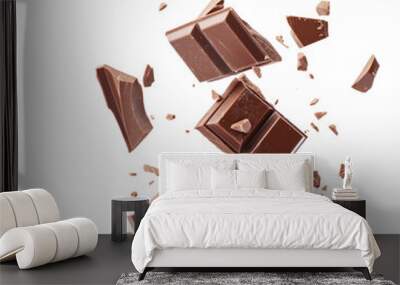 Broken chocolate bar pieces falling isolated on white background. Wall mural