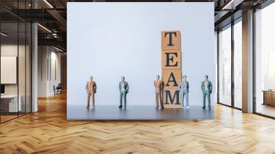 miniature people figurine stamd on white background. wooden stamp combine the word Team, challenge for business success.Teamwork concept idea. Wall mural