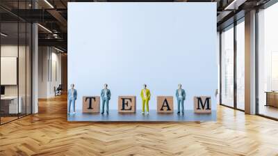 miniature people figurine stamd on white background. wooden stamp combine the word Team, challenge for business success.Teamwork concept idea. Wall mural