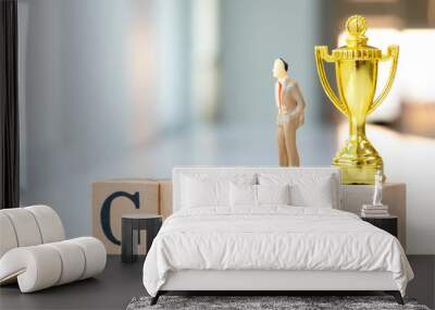 Miniature people : Trophy and businessman on goal text wooden blocks. Wall mural