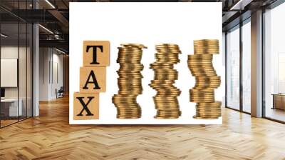 word tax in wooden blocks and stacked gold coins on white background Wall mural