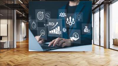 Analyzing ROI and Business Strategy Concepts. Businessman working on a laptop with various digital icons representing ROI, financial strategies, return on investment, and efficiency. marketing plan, Wall mural