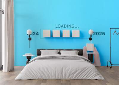 Loading Progress Bar from 2024 to 2025 with Wooden Blocks. A hand places wooden blocks in a row, creating a progress bar transitioning from 2024 to 2025, symbolizing the new year and future progress. Wall mural