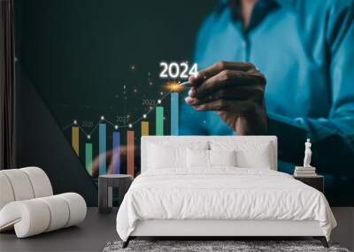 The 2024 New Year business goals concept. Businessman analyzes graph of trend market growth in 2024 and plans business growth and profit increases. calculates financial data for long-term investments. Wall mural