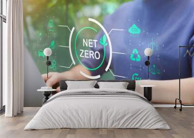 Woman use laptop with environmental carbon reduction icon or net zero technology. carbon neutrality. Carbon footprint, CO2 emissions, Sustainable energy, Global warming, Greenhouse gas, Climate change Wall mural