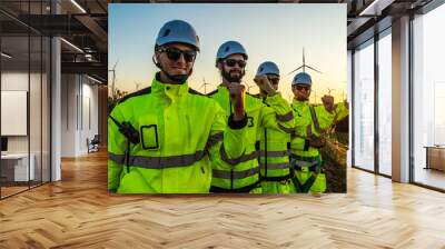 group of male engineers in uniform work together as a wind turbine maintenance team in a wind turbine field at sunset, using wind energy to generate electricity. Wall mural