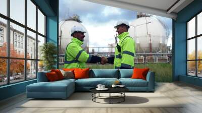 Two Male Engineer Group In Uniform walk together to inspect the work. Check Gas Leakage Pipe System and Maintenance System and Training Oil Refinery at Column Tank Oil of Petrochemistry Industry. Wall mural