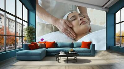 Young woman lying down on massage bed massage from masseur at spa and wellness center.Beauty ,Relax and spa concept. Wall mural