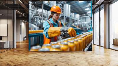 A worker in a safety uniform operating a large canning machine in a food production facility Wall mural