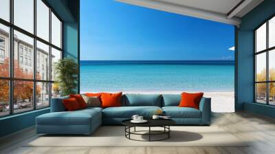 A panoramic view of the pristine white sandy beach, with two wooden sun loungers under an umbrella on one side and clear blue water in front, creating a serene vacation scene. Wall mural