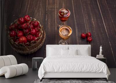 Alcoholic drinks in glass piles on a wooden table. Cherry, nut and lemon liqueurs. Wall mural