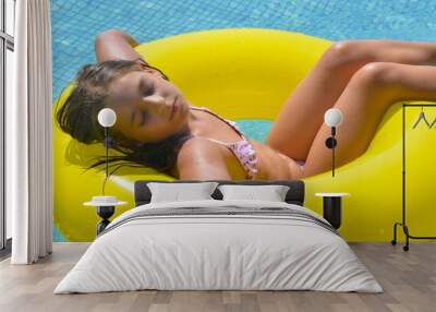 Real adorable girl relaxing in swimming pool Wall mural