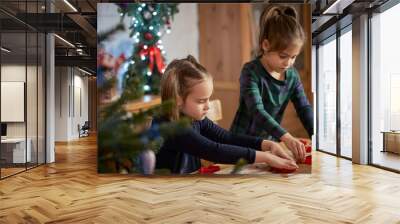 two cute sisters make and decorate Christmas gingerbread cookies Wall mural