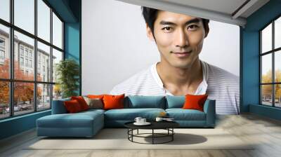 A young Asian man with short, black hair and a confident smile, dressed in a light gray striped shirt. Wall mural