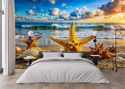 Close-up of starfish and a variety of shells on sandy beach against a backdrop of waves and clouds. Wall mural