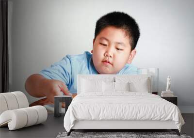 Fat Asian children are eating pizza on a white table with soda nectar. White background. Child weight control concepts Wall mural