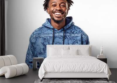 Front view mid shot of a handsome African man dressed in a blue hoodie and patterned jogger pants, smiling on a white transparent background Wall mural