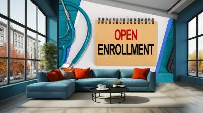 Notepad with text OPEN ENROLLMENT, calculator and stethoscope. Wall mural