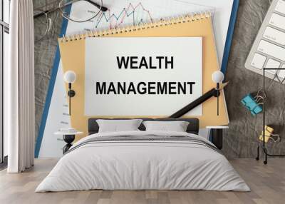 Wealth Management is written in a document on the office desk Wall mural