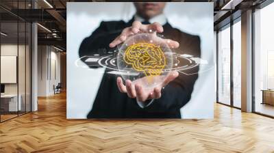 A business man holding a abstract brain hologram uses circular network communication with people around the world. Concept of the digital world technology development science of the future. Wall mural