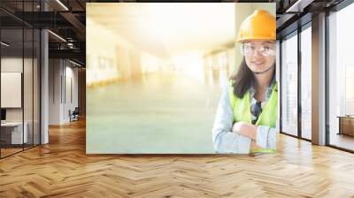 Double exposure of Woman engineering wearing yellow helmet and working at factory site Wall mural