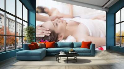 beautiful and healthy young woman relaxing with face massage  at beauty spa salon Wall mural