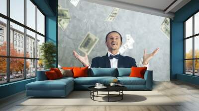 Happy business man very rich guy throw money dollar bills in air like rain money bill - business success concept Wall mural