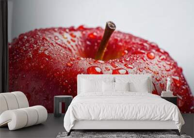 A close-up of water droplets on a bright red apple, emphasizing its freshness and juicy appeal against a clean white background Wall mural