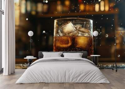 Close-up of a glass of whiskey and soda, ice cubes floating while tiny bubbles dance around the glass, with a rustic bar background Wall mural