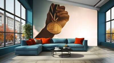 A person proudly holding up a gold medal Wall mural