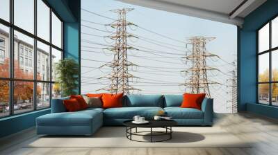 Electricity pylon silhouetted against blue sky background. High Wall mural