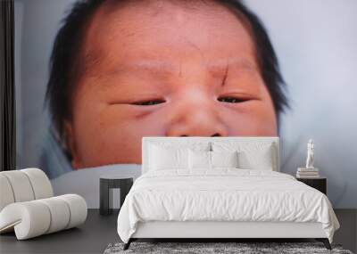 A wound on the newborn's forehead caused by a scalpel in the delivery room. Close up Newborn Baby in the Incubator with Wounds on the Forehead Happened from  the cesarean section. Wall mural