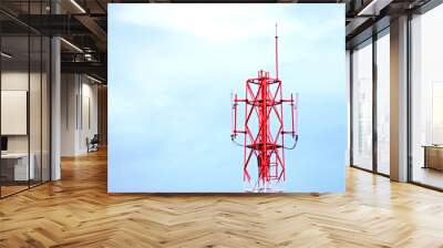 Telecommunication tower with cloudy background. Wall mural