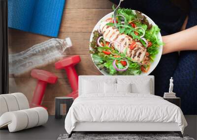 Healthy and fitness food. Chicken salad dish with fitness equipments Wall mural