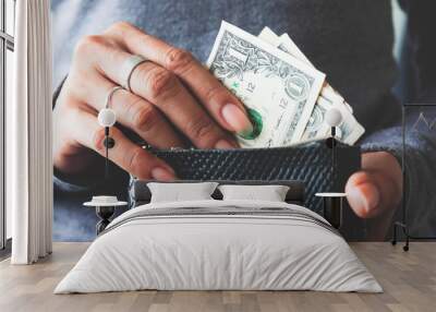 Paper currency in wallet with woman hands. Wall mural