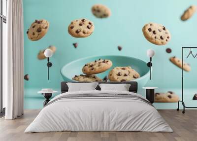 A bowl of chocolate chip cookies surrounded by floating cookies and chocolate chips. Wall mural