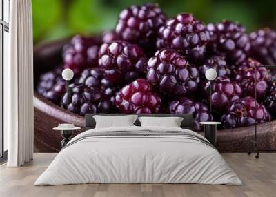 A bowl of fresh blackberries on a wooden surface, highlighting their natural beauty. Wall mural