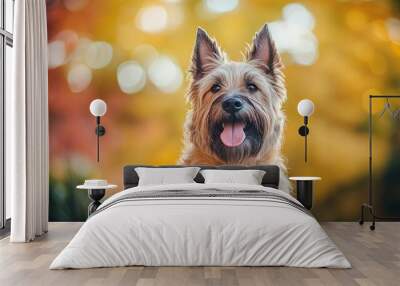 A cheerful dog with a playful expression against a colorful autumn background. Wall mural