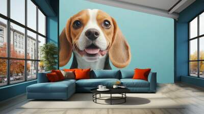 A close-up of a cheerful beagle dog with a playful expression against a blue background. Wall mural