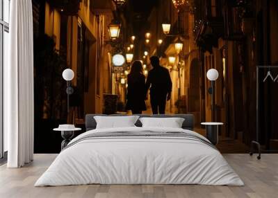 A couple walks hand-in-hand through a dimly lit alley adorned with warm lights. Wall mural