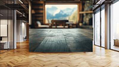 A cozy cabin interior with a wooden table and a scenic mountain view. Wall mural