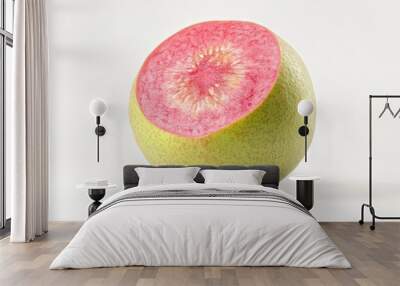 A halved guava showcasing its vibrant pink interior and green exterior. Wall mural