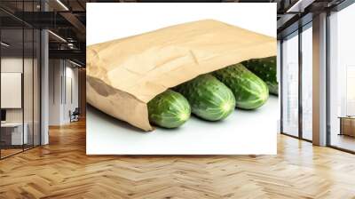 A paper bag containing four fresh cucumbers. Wall mural