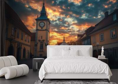 A picturesque town square at sunset, featuring a clock tower and charming buildings. Wall mural