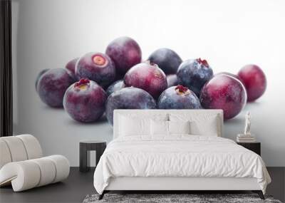 A pile of fresh blueberries on a white background, showcasing their vibrant color and texture. Wall mural