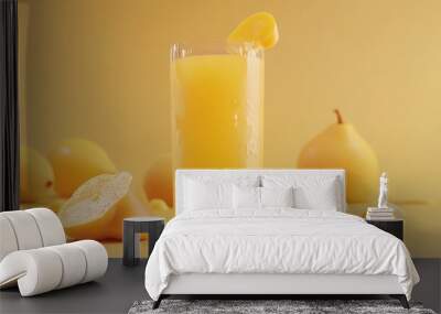 A refreshing glass of yellow juice surrounded by lemons and pears on a matching background. Wall mural